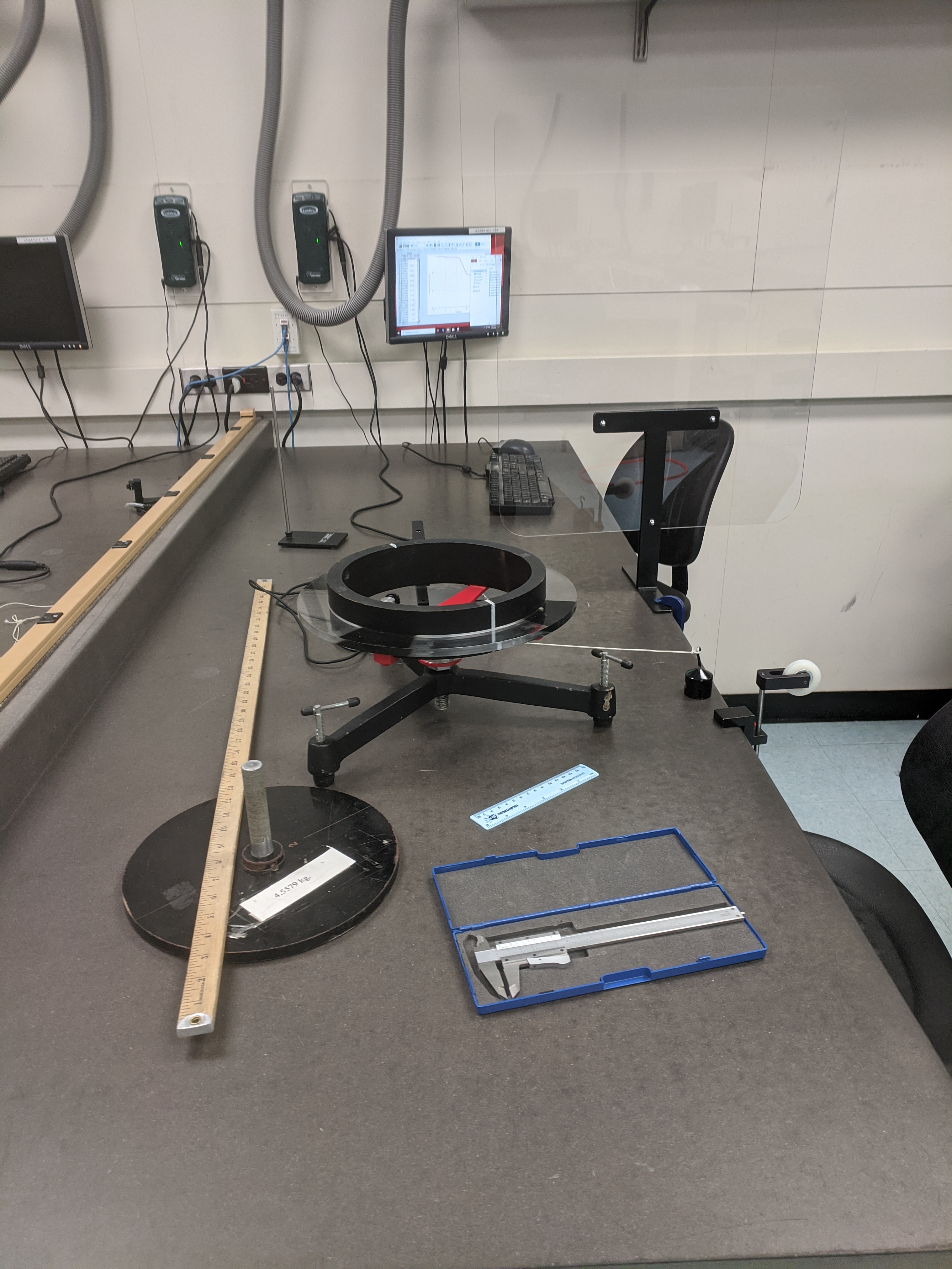 Lab bench showing Angular Momentum experiment and protective shield